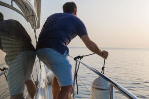 crew is holding a fender on superyacht