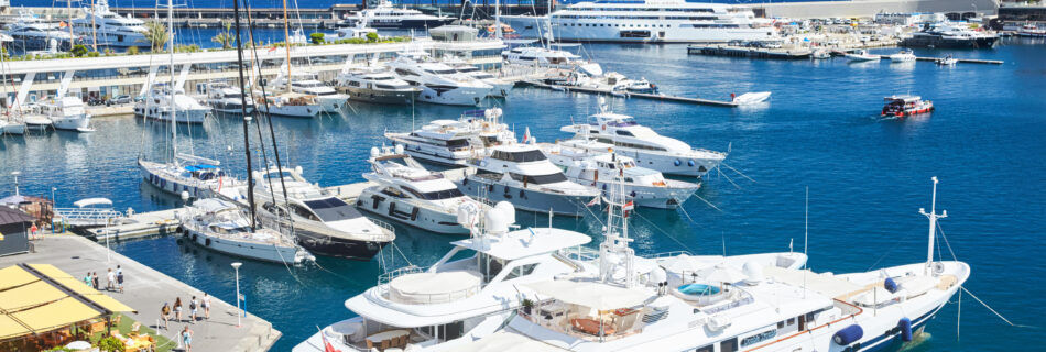 Monaco, Monte-Carlo, Monaco Ville, 8 August 2016: Port Hercules, the preparation of the yacht show MYS, sunny day, many yachts and boats, RIVA, Prince's Palace of Monaco, megayachts, Massif of houses