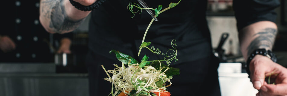 Chef plating and decorating food on a yacht