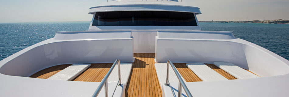 View over the bow of a large luxury motor yacht on tropical open ocean with bridge