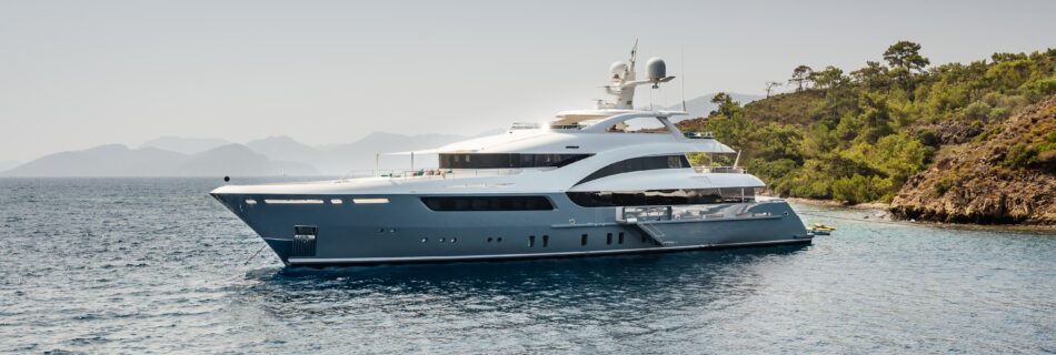 A large private luxurious modern private yacht around the island on a background of the sky